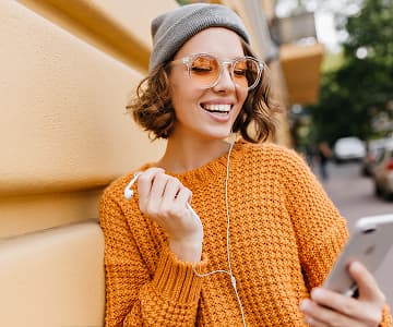 Woman smiling while using a smartphone for online courses