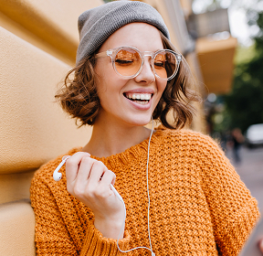 Woman smiling while using a smartphone for online courses