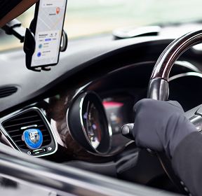 Smartphone displaying taxi service app in a car
